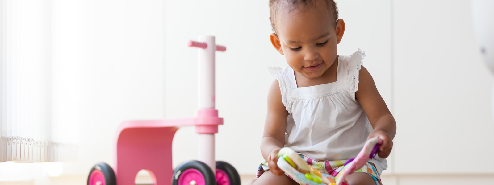 ToyLibraryGhana-Banner-Child-Pink-Bike